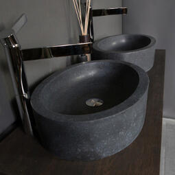 oval stone basin with tall tap