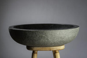 small round stone sit on basin 