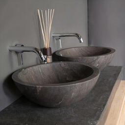 brown round stone basin and wall hung taps