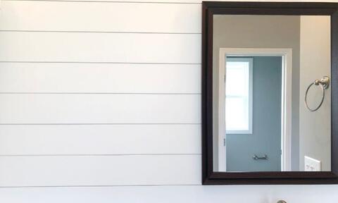 Big Rectangular Bathroom Mirror Against A White Wall