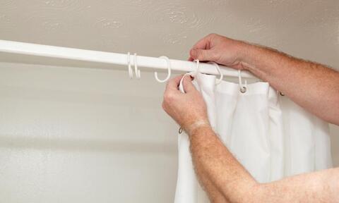 Man Hands Attaching Bathroom Shower Curtains To Hooks