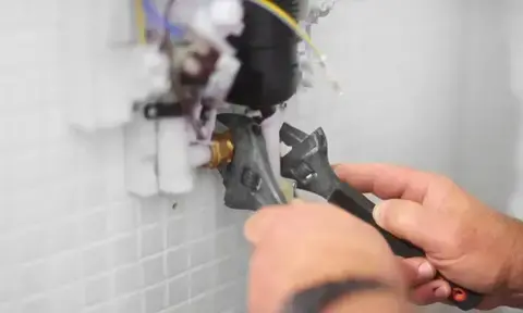 Man Hands Fixing Bathroom Pipe By Using Wrenches