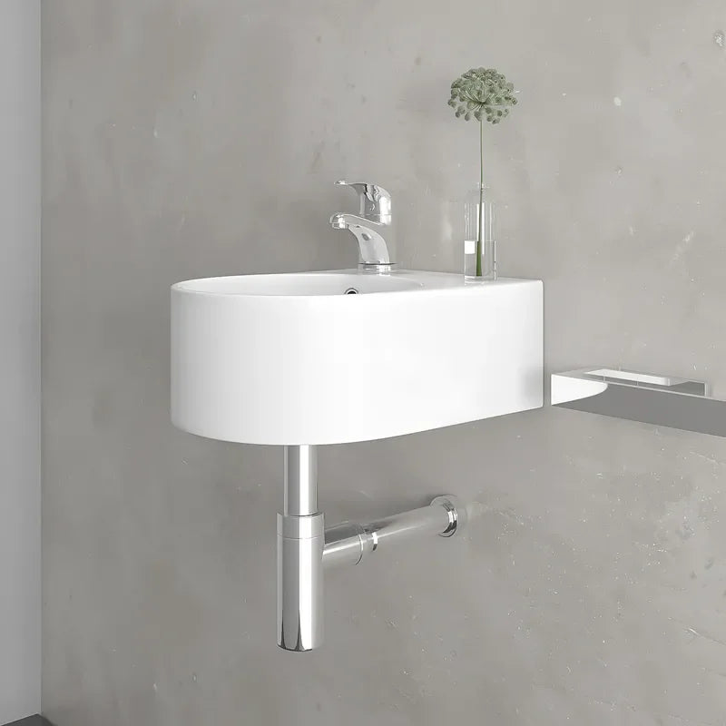 Round bottle trap in chrome, compact space-saving design shown installed beneath wall hung basin