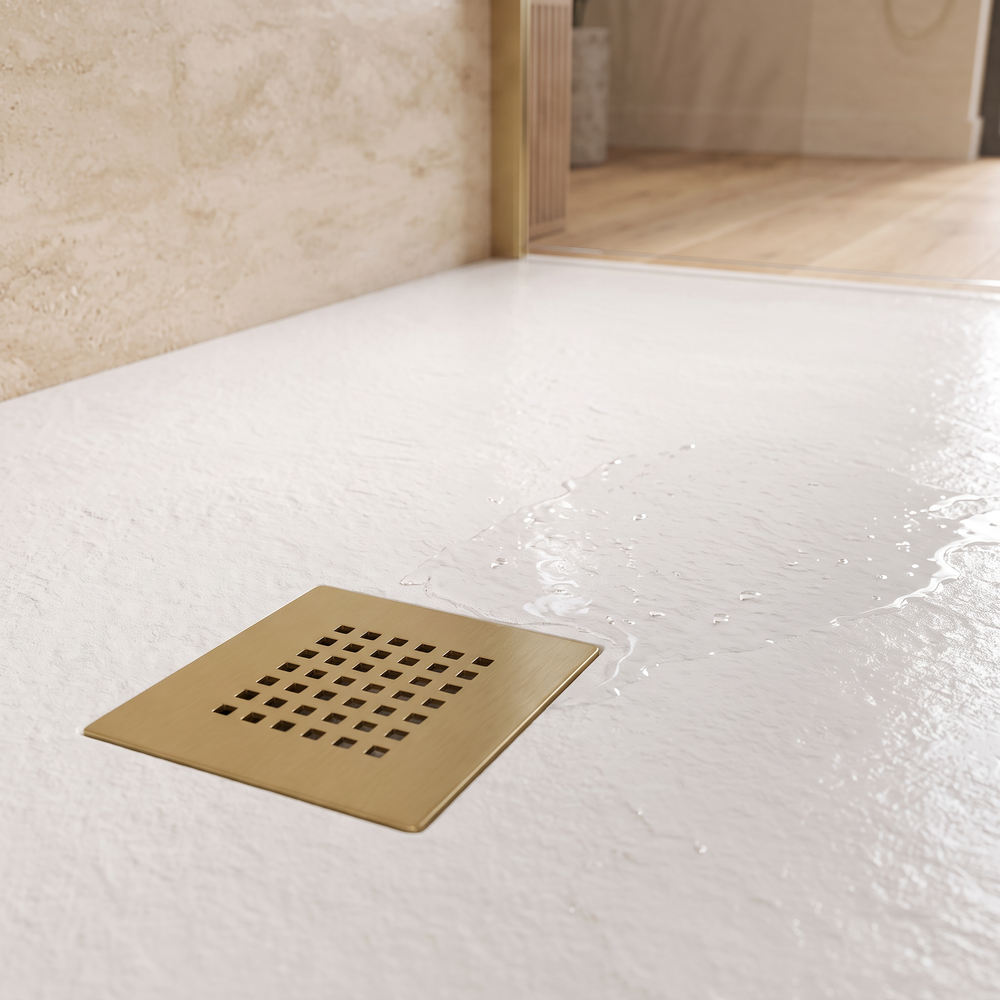 White slate-effect shower tray with square brushed brass waste grille