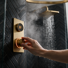 Brushed brass digital shower valve set to 38 degrees inside the shower enclosure