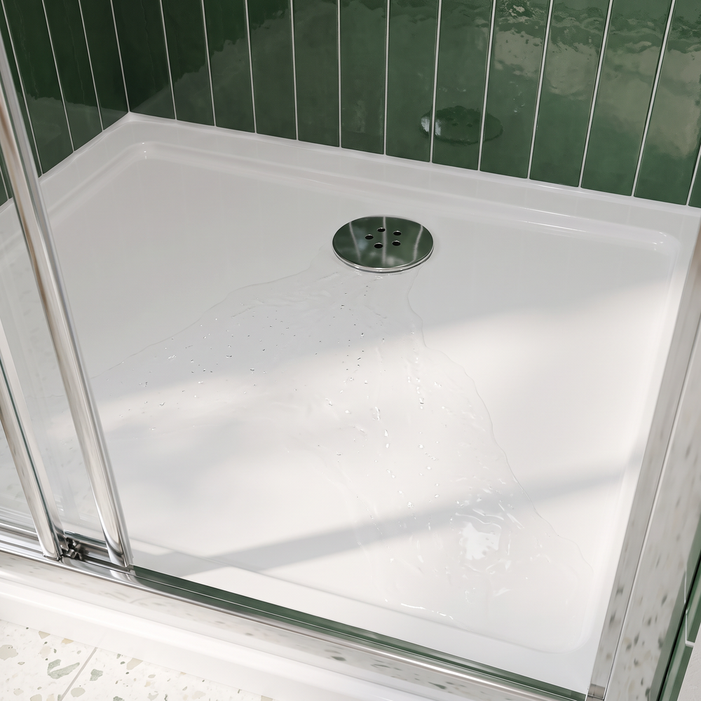 White anti-slip shower tray with round chrome 90mm waste at the back