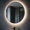 800mm round LED backlit bathroom mirror glowing on a grey stone wall above the Linnea vanity unit