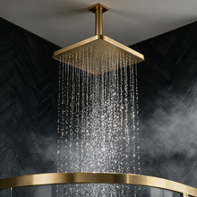 250mm square brushed brass rainfall shower head on a ceiling mounted arm
