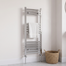 300 x 800mm chrome heated towel rail with angled radiator valves and a white towel