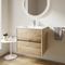 Akron 600mm wall hung vanity in rustic light oak with white ceramic basin, handleless drawers, in an oak-floored bathroom