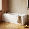 1700 x 700 single ended bath with white panels and brushed gold bath filler tap in a warm bathroom