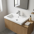 Sidaw chrome waterfall basin mono mixer on a white basin with fluted oak vanity and terrazzo floor
