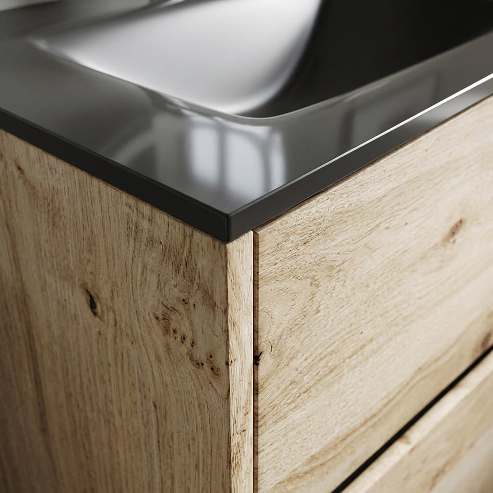 Detail of glossy black glass basin edge and rustic light oak veneer grain on the Akron vanity