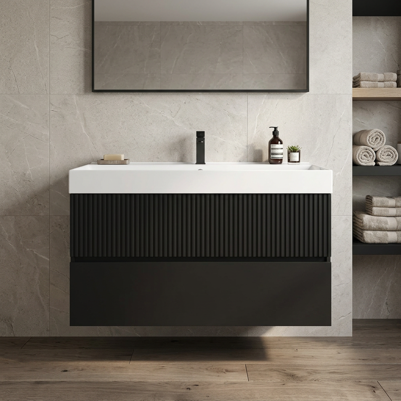 Linnea 1000mm matt black wall hung vanity with fluted top drawer and white basin in a stone-tiled bathroom