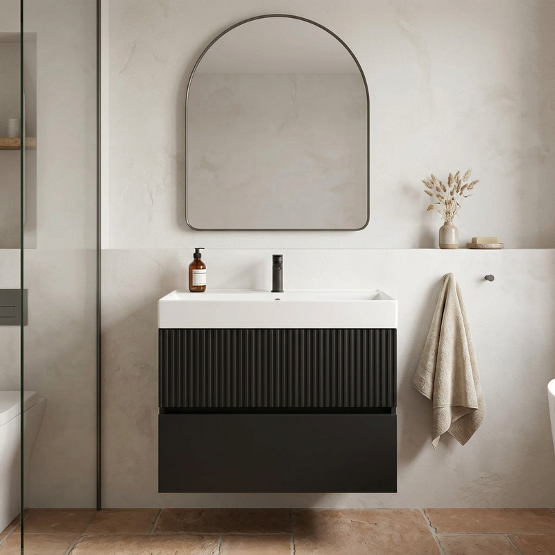 Linnea 700mm matt black wall hung vanity with fluted top drawer and white basin in a plaster-walled bathroom