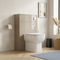 Pemberton 600mm back to wall toilet unit in light taupe latte gloss with white pan and soft close seat, in situ