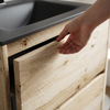 Close-up of hand opening the handleless finger-pull drawer on the Akron rustic light oak vanity, black basin