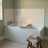 1700 x 700 single ended bath filled with water and a bath caddy