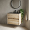 Akron 600mm wall hung vanity in rustic light oak with black glass basin, handleless drawers, in a limewash bathroom