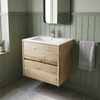 Akron rustic light oak wall hung vanity with white basin, three-quarter view against sage green panelling