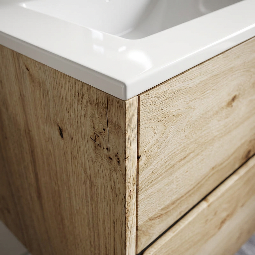 Detail of rustic light oak veneer grain and white ceramic basin edge on the Akron vanity