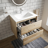 Akron rustic light oak vanity with both handleless drawers open showing storage, white ceramic basin