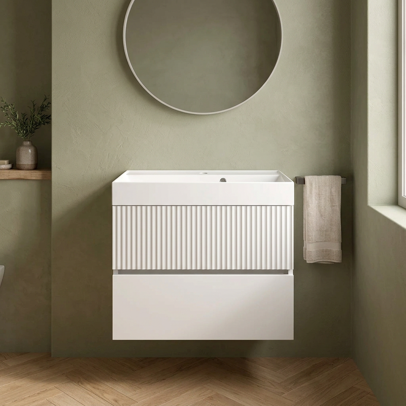 Linnea 700mm matt white wall hung vanity with fluted top drawer and white basin in a sage green bathroom