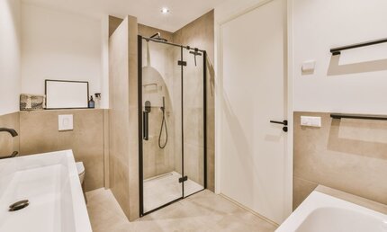 A Bathroom Space with Black Frame Small Shower Cubicle