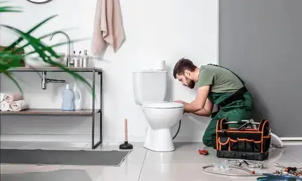 Man Installing a New Toilet