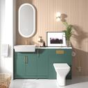 Matt green fitted furniture with brushed gold handles, taps and flush plate