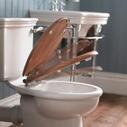 Room Scene View of a Traditional Close Coupled Toilet with Closing Wooden Seat