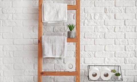 White Bath Towels Hanged On a Wooden Towel Holder