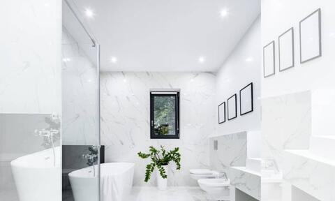 White Bathroom With Bathroom Lights Turned On