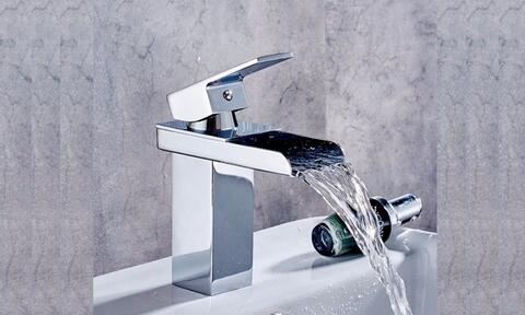 Image-Of-Small-Chrome-Bathroom-Basin-Waterfall-Tap-With-Flowing-Water