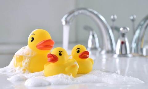 Yellow Duck Toys Floating In A Bath