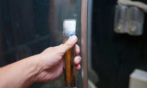 Hand Holding Shower Door