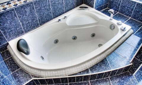 Corner Whirlpool Bath with Blue Tiles Around