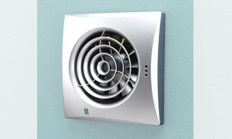 Square Extractor Fan Attached To A Teal Colored Wall