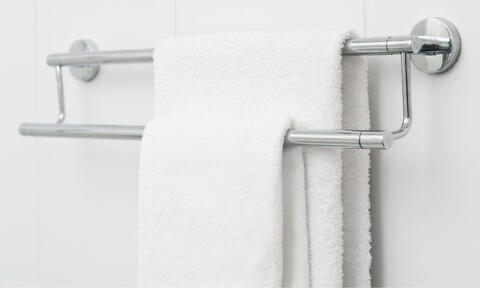 White Towel Hanged In a Chrome Towel Hanger