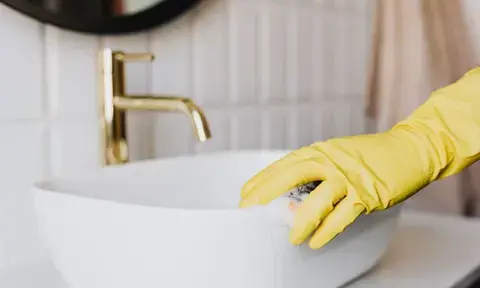 Hand Gloved Deep Cleaning Bathroom Sink