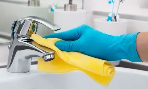 Hand Gloved Deep Cleaning Bathroom Tap