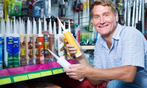 Man Holding a Protective Sealant Tube