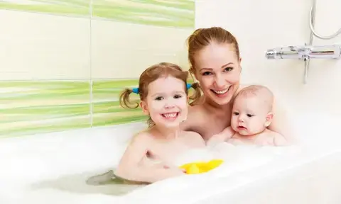 Mother and 2 Daughters Smiling on Bathtub