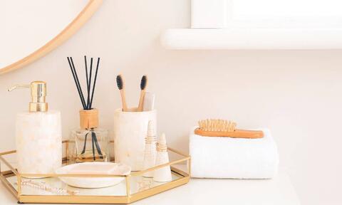 Sets of Hairbrush and Toothbrush Above a Vanity Unit