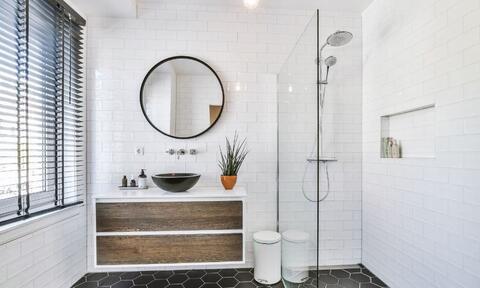 White Bathroom With Countertop Vanity Unit, Bathroom Mirror, and Shower Baths