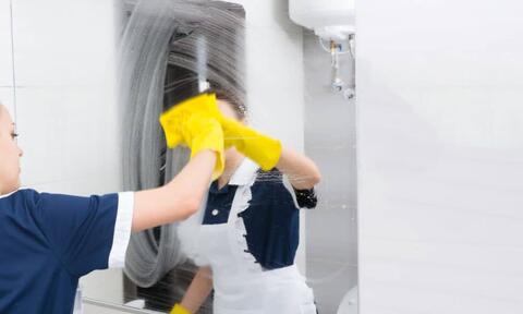 Soap Rub A Woman Cleaning Bathroom Mirror With Using A Yellow Dampen Cloth