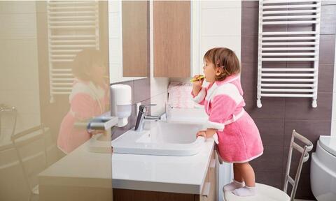 A Girl Child Brushing Her Teeth