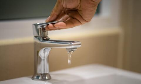 Turn Off the Faucet When Not Using It Man Hand Turning Off a Faucet