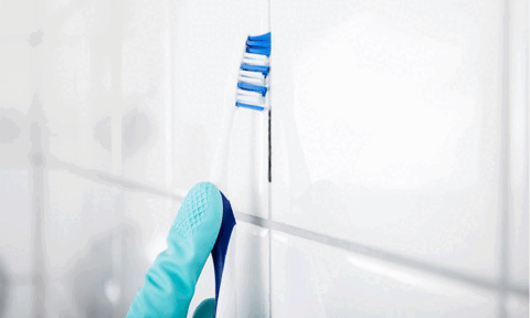 Removing Bathroom Grout By Using Toothbrush