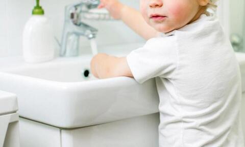 A Child Washing His Hands